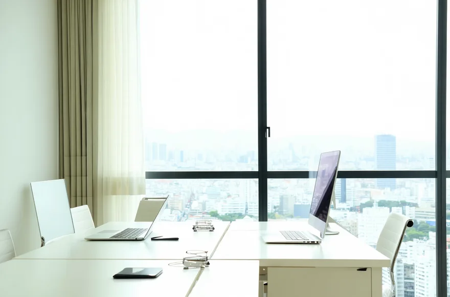 Rezon team working in a small modern office space in Tokyo Nishishinjuku, collaborative atmosphere